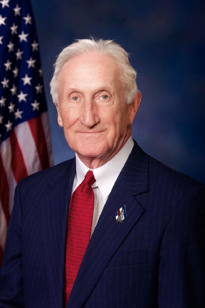 Photorealistic portrait of George Washington, dressed in a modern business suit and standing in front of an American flag. Citation: redditKingBaboon97, “I Created a Photorealistic Image of George Washington If He Lived in the Present Day.,” Reddit Post, R/Interestingasfuck, May 2, 2021, https://www.reddit.com/r/interestingasfuck/comments/n39zq5/i_created_a_photorealistic_image_of_george/.

